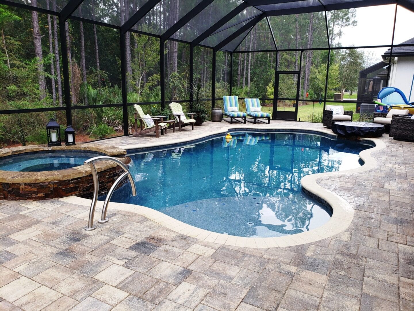 A pool with chairs and a bench in the middle of it.