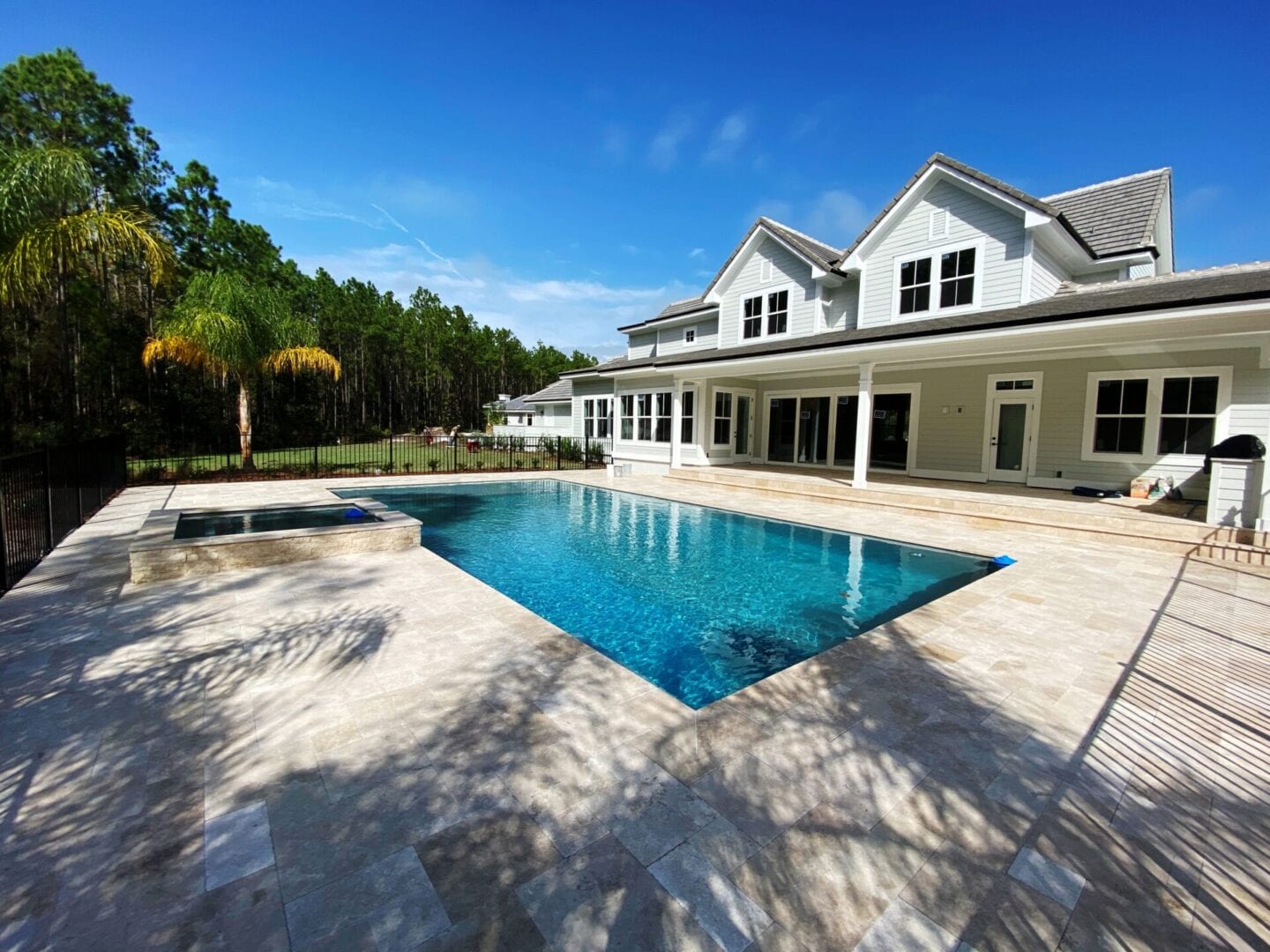 A large pool in front of a house.